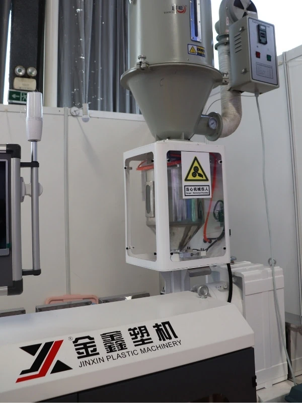 Loss-in-weight hopper system on a plastic extrusion line showing load cell mounting and isolated hopper design